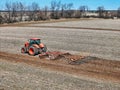 Kubota M7-152 tractor pulling a Case Disk Harrow & finisher to prep the field for spring planting