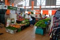 Woman customer examines and chooses fresh vegetables Satok market Kuching Malaysia