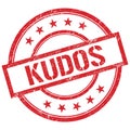 KUDOS text written on red vintage stamp