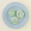 Three Kuih Lopes on a blue round plate. square photo image.