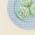 Three Kuih Lopes on a blue round plate. circular.