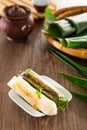 Kuih Pulut Panggang grilled glutinous rice wrapped in banana leaf with stuffed savory fillings