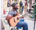 Kuku, itinerant folk musician, playing outside Shakespeare and C