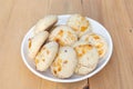 Kulcha e khataye biscuits in white plate with a wooden background Royalty Free Stock Photo