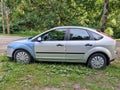 Kuldiga, Latvia - August 3, 2022: Ford Focus car in silver color with with different colored front wings