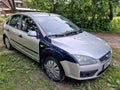 Kuldiga, Latvia - August 3, 2022: Ford Focus car in silver color with with different colored front wings