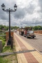 Kuldiga, Latvia - July 3, 2023: Kuldiga brick bridge over Venta with tourist transporter locomotive