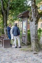 Kuldiga, Latvia - July 3, 2023: People tourists looking at notice information board