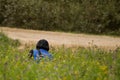 Kuldiga, Latvia - September 17, 2016: FIA ERC Liepaja Rally. The photographer squats in the meadow, near the road