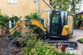 Kuldiga, Latvia - September 12, 2022: Sewer repair. Excavated pit, excavator and drain cover