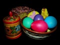 Kulich, painted eggs, Khokhloma dishes isolated on a black background. The celebration of the Orthodox Easter holiday.