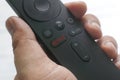 KULIM,MALAYSIA - CIRCA APRIL,2020 : A hand holding an android box remote control with a Netflix button.Netflix company`s primary Royalty Free Stock Photo