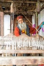 Kullu, Himachal Pradesh, India - August 09, 2018 : An Indian old man makes a traditional sadu weaving