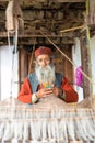Kullu, Himachal Pradesh, India - August 09, 2018 : An Indian old man makes a traditional sadu weaving Royalty Free Stock Photo
