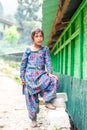Kullu, Himachal Pradesh, India - August 31, 2018 : Portrait of himachali girl near her house in himalayas Royalty Free Stock Photo