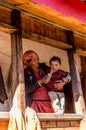 Kullu, Himachal Pradesh, India - December 21, 2018 : Photo of himalayan woman with kid in wooden house in himalayas