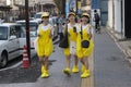 Japanese teenage girls dressed like chickens making fun in the shoppingstreet