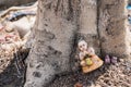 Kuman Thong.The baby doll was left at the base of the tree