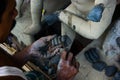 Kumartuli,West Bengal, India, July 2018.An artisan working on shaping the hand of a clay idol of Goddess Durga at a shop during ni