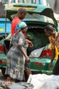 Unidentified Ghanaian people loads goods into the trunk at the Royalty Free Stock Photo