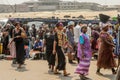 Unidentified Ghanaian people walk at the Kumasi market.