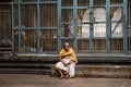 An aged priest sitting in a temple