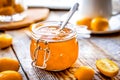 Kumquat on plate and jam in jar at wooden table