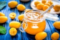 Kumquat on plate and jam in jar at wooden table Royalty Free Stock Photo