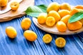 Kumquat on plate at wooden table