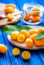 Kumquat on plate at wooden table
