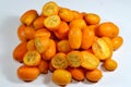 Kumquats, cumquats, a group of small, angiosperm, fruit-bearing trees in the family Rutaceae, golden orange, an edible fruit Royalty Free Stock Photo