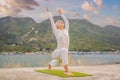 Kundalini yoga woman in white clothes and turban practices yoga kundalini on the background of the sea, mountains and