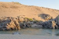 Kunene River in front of towering ancient Namib Desert sand dunes of Namibia and Angola Royalty Free Stock Photo