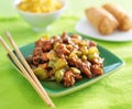 Kung pao chicken on green plate.