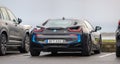 Black 2016 BMW i8 hybrid electric car at a parking lot..