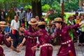 Kunming, China - 12 July 2019: Chinese people dancing in the public park wearing ethnic traditional costumes