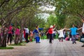 Kunming, China - 12 July 2019: Chinese people dancing in the public park wearing ethnic traditional costumes Royalty Free Stock Photo