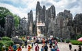 Chinese tourists in front of the limestone formations of Shilin major stone forest park in Yunnan China