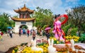 Chrysanthemum flowers and statue at Grand view park with people in front of a pavilion in Kunming Yunnan China Royalty Free Stock Photo