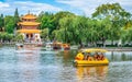 Kunming Daguan Yuan park panorama with Grand View Lou tower and people on small duck boat on Dianchi lake in Kunming Yunnan China