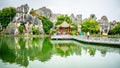 Lianhua lake with path people and small pavilion and karst water reflection at Shilin Stone forest Yunnan China