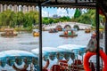 Small boats with people on Dianchi lake inside Grand view park and Cuiyu stone bridge scenic view in Kunming Yunnan China