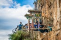 Tourists under the Longmen dragon gate and Xishan west hill cliff view in Kunming Yunnan China