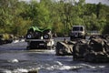 Kununurra, Australia - November 8, 2010. Offroad trucks parked at Ivanhoe Crossing and people swimming in river, Kununurra,