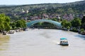 Kura river and modern futuristic glass bridge, center of Tbilisi