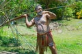 Aborigine actor throws a spear in the Tjapukai Culture Park in Kuranda, Queensland, Australia. Royalty Free Stock Photo