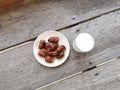 Kurma or sweet dried date palm fruit, served on plate together with milk for breaking fast ramadhan food. Royalty Free Stock Photo