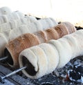 Kurtos kalacs or chimney cakes, preparing cooking on charcoal grill