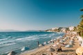 Kusadasi, Aydin Province, Turkey. People Resting At Beach Of Resort Town. Many Umbrellas On Sandy Beach During Sunset.