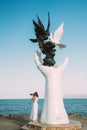 Kusadasi, Aydin Province, Turkey. Young Woman Tourist Traveler Photographer Taking Pictures Photos Near Hand Of Peace